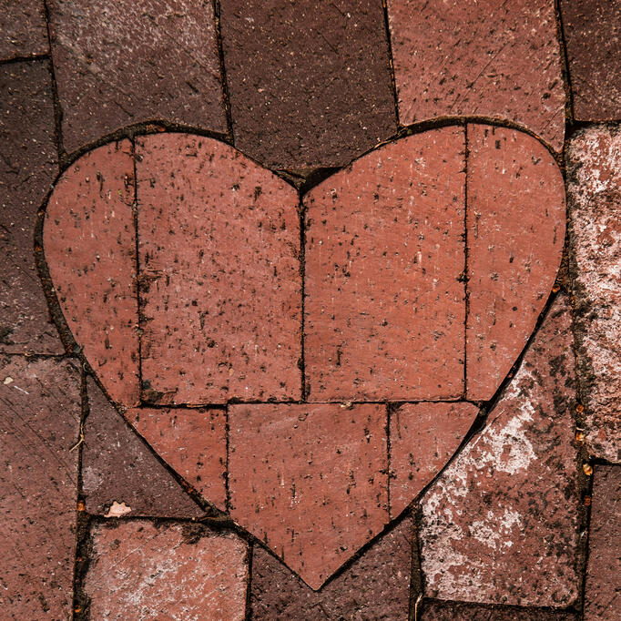 Heart made of stones representing compassionate, solid and grounded support